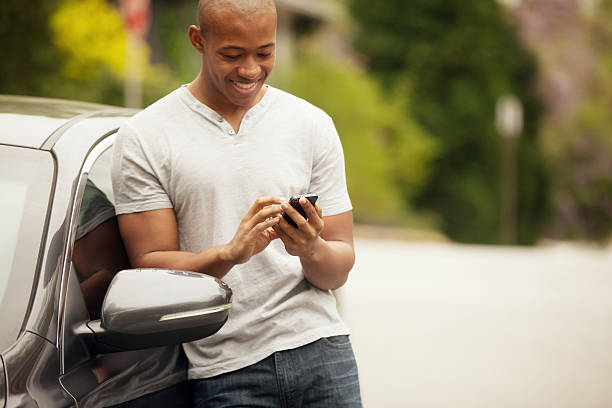 Young man happily texting. Young man happily texting.